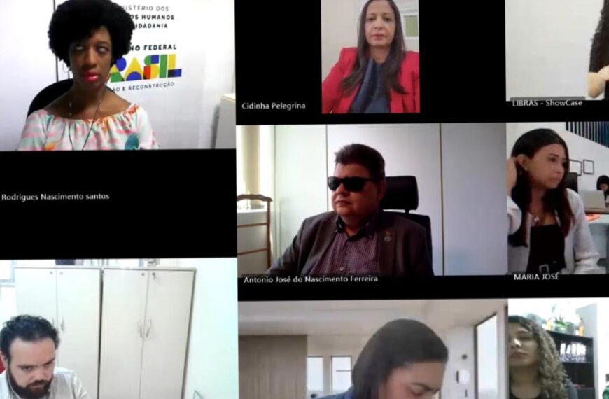 Videoconferência formal com 8 participantes, diversidade de gênero e intérprete de LIBRAS presente.
