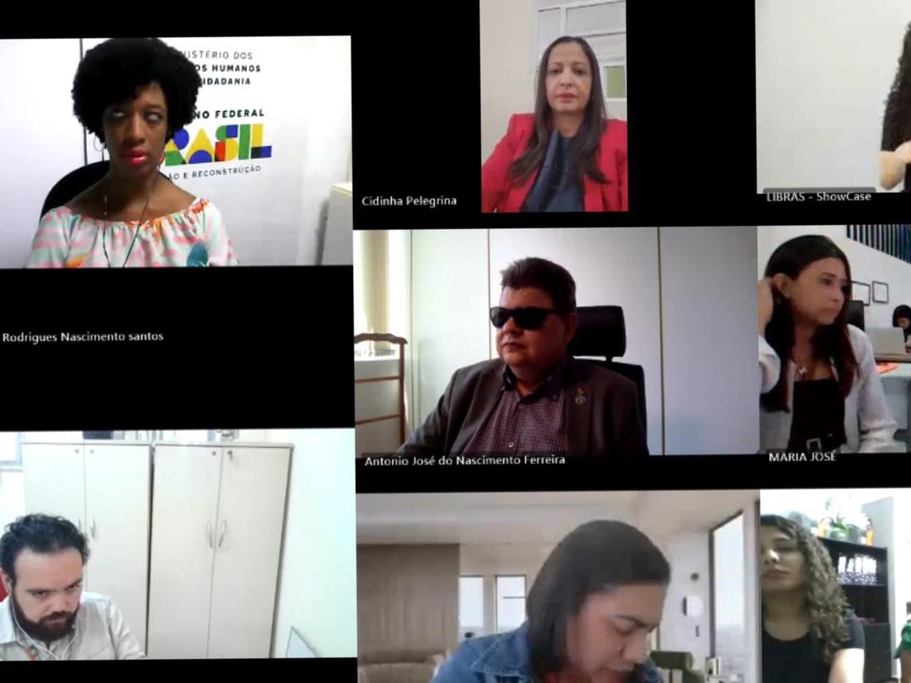 Videoconferência formal com 8 participantes, diversidade de gênero e intérprete de LIBRAS presente.